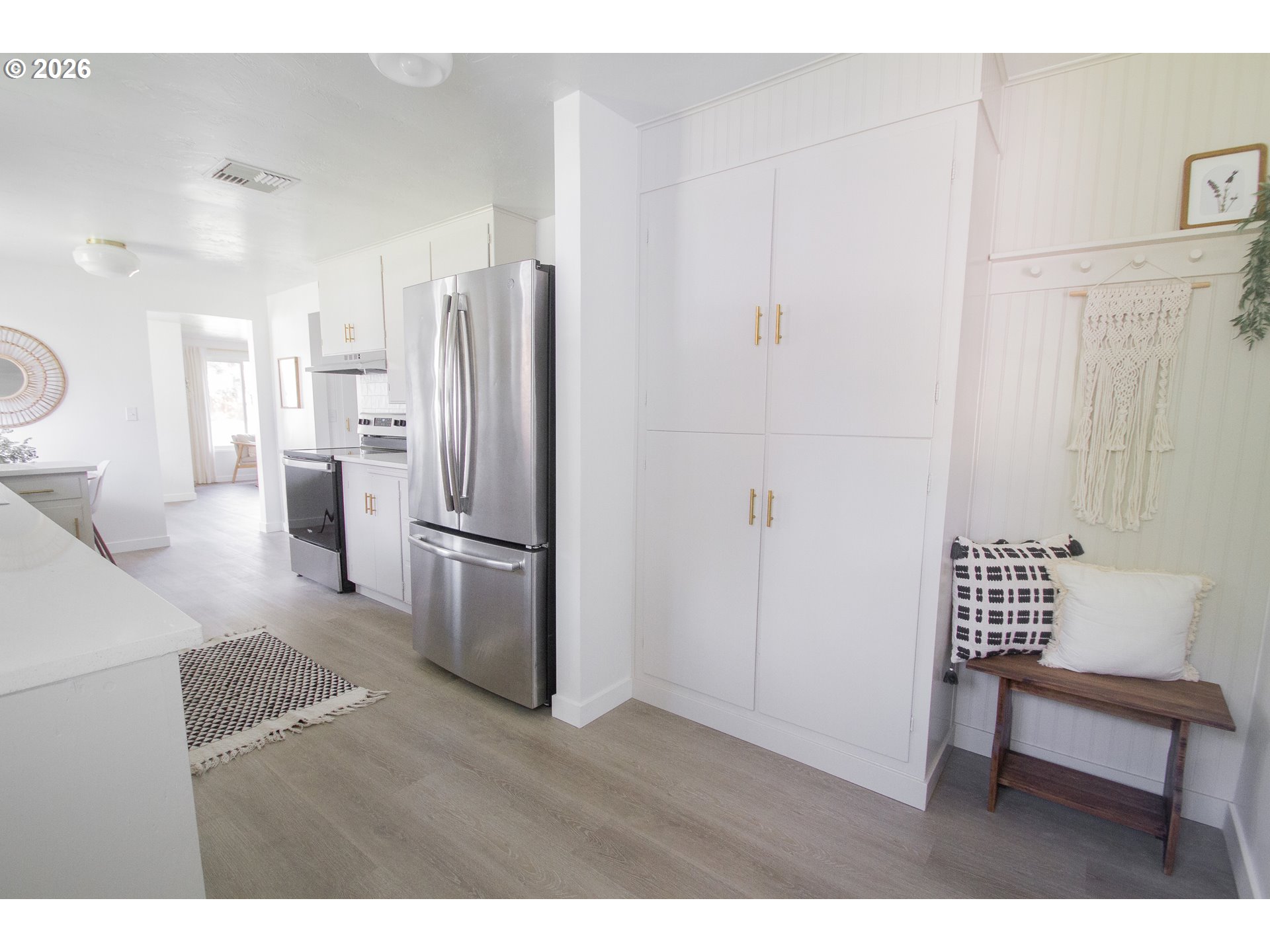 1490 Taft Street Eugene, OR 97402 - Photo 25 of 36 a kitchen with a refrigerator and a wooden cabinets