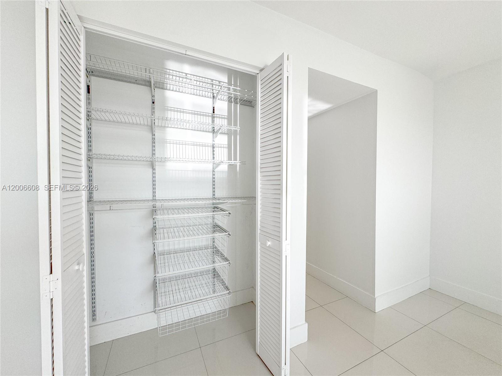 210 Seaview Drive, Unit 403 Key Biscayne, FL 33149 - Photo 18 of 31 a view of walk in closet with empty racks