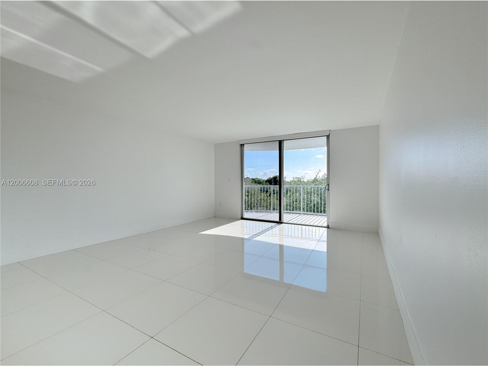 210 Seaview Drive, Unit 403 Key Biscayne, FL 33149 - Photo 2 of 31 wooden floor in an empty room with a window