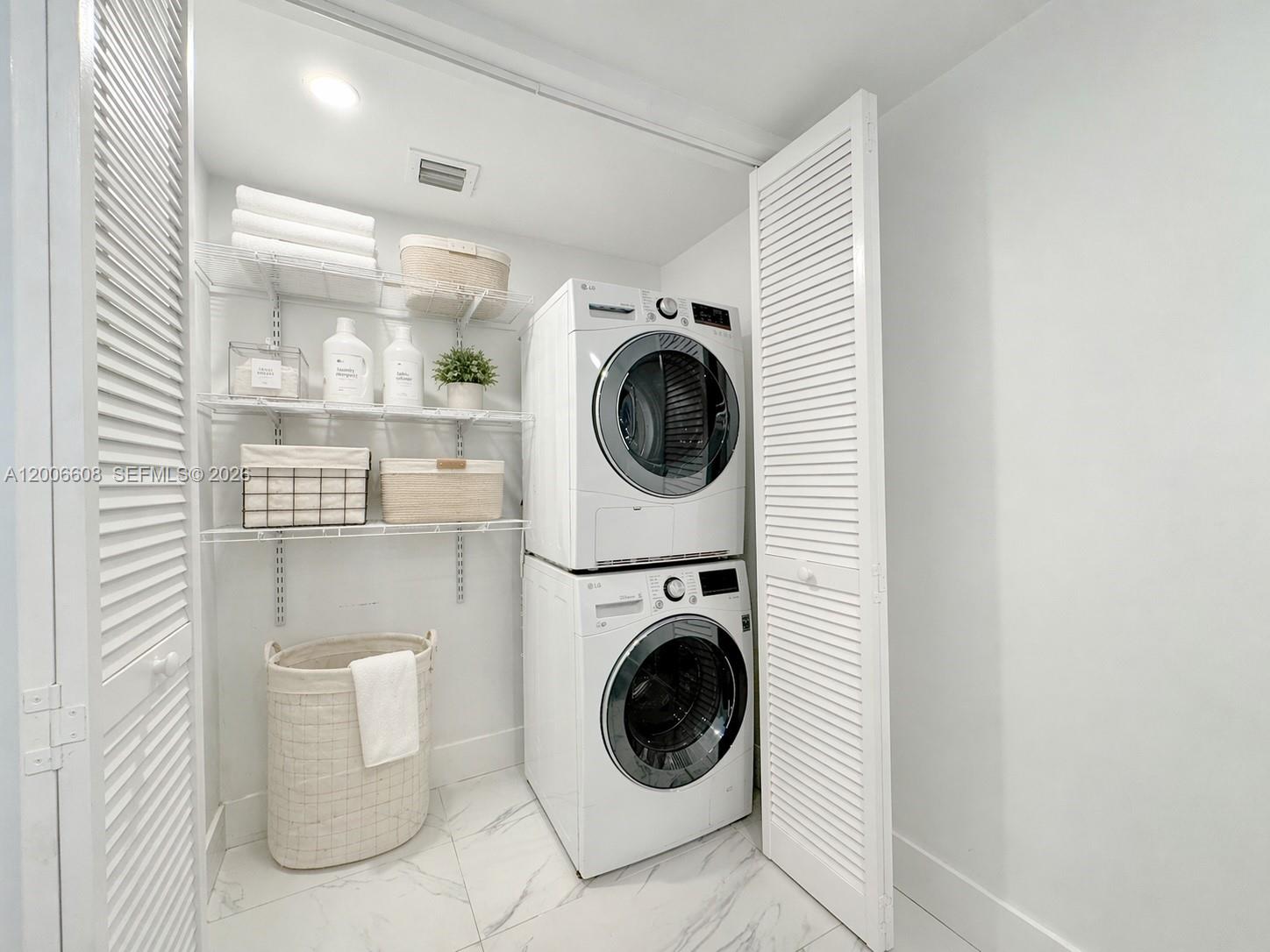 210 Seaview Drive, Unit 403 Key Biscayne, FL 33149 - Photo 22 of 31 a utility room with sink dryer and washer