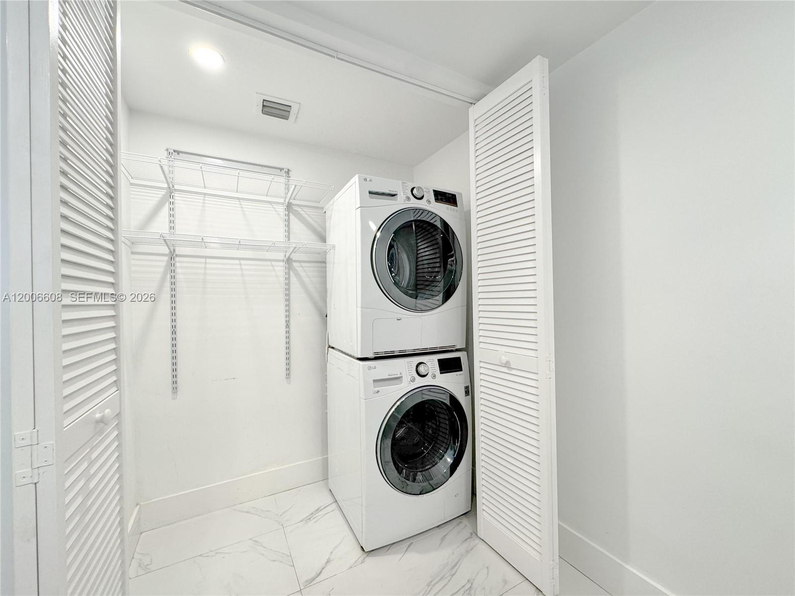 210 Seaview Drive, Unit 403 Key Biscayne, FL 33149 - Photo 23 of 31 a utility room with sink dryer and washer