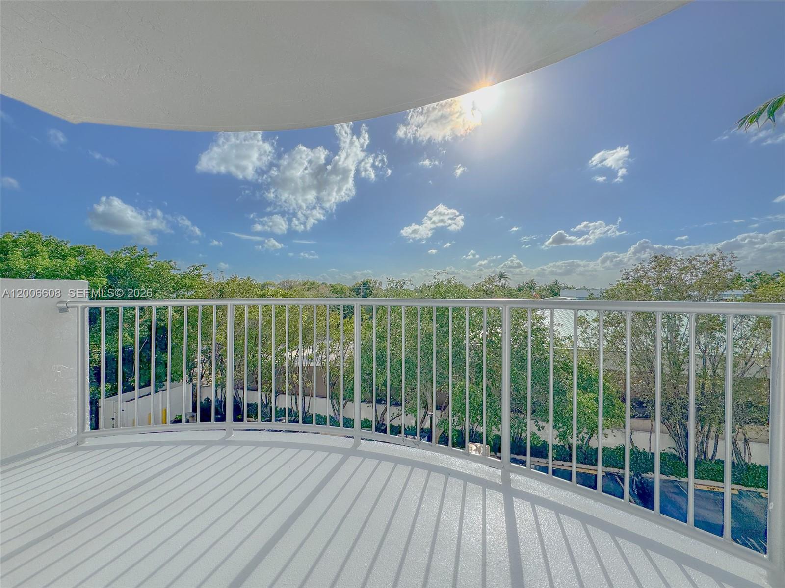210 Seaview Drive, Unit 403 Key Biscayne, FL 33149 - Photo 26 of 31 a view of a balcony with floor to ceiling windows with wooden floor