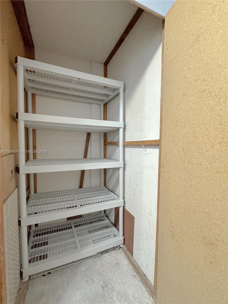 210 Seaview Drive, Unit 403 Key Biscayne, FL 33149 - Photo 28 of 31 a view of walk in closet with empty racks