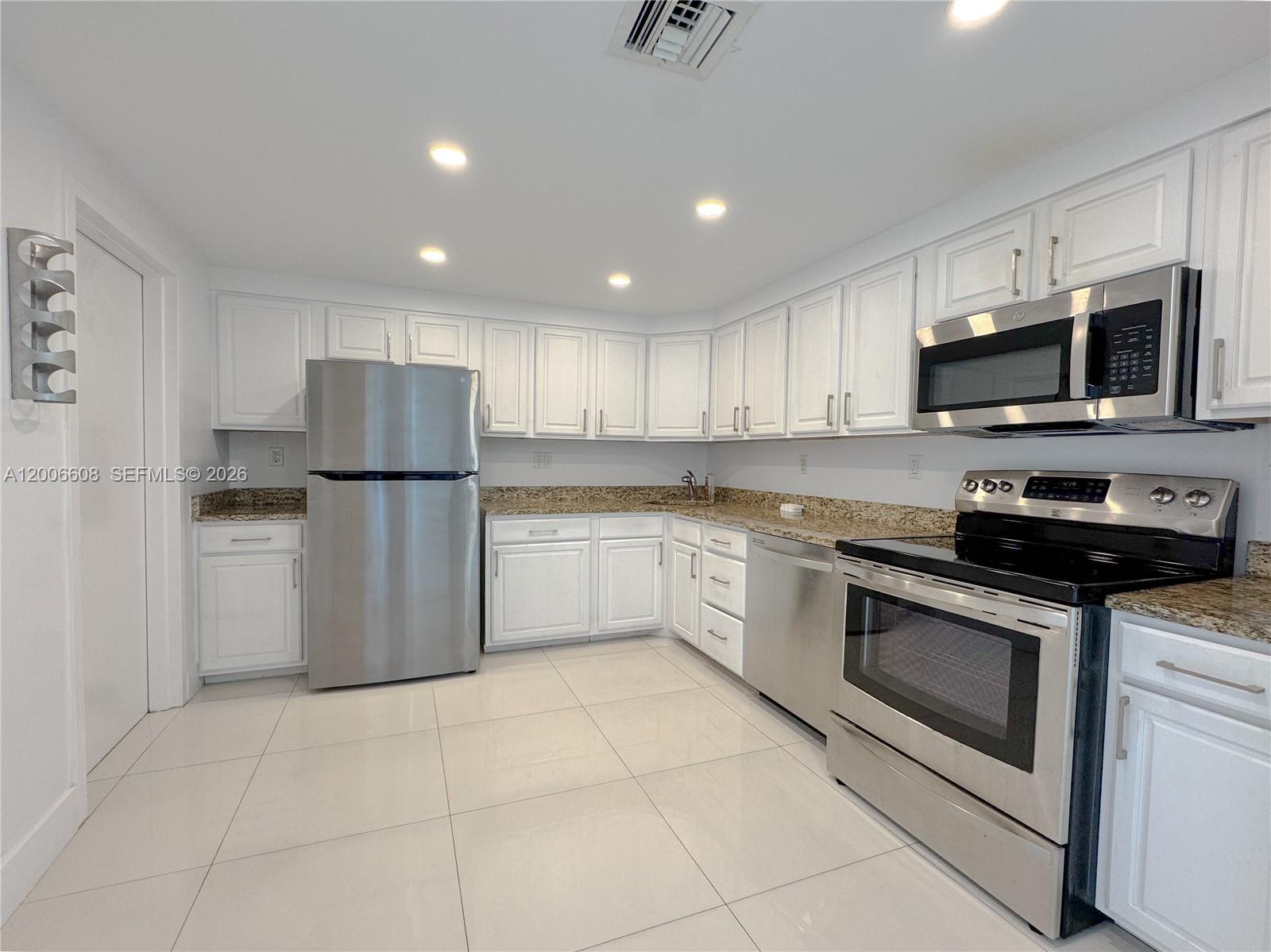 210 Seaview Drive, Unit 403 Key Biscayne, FL 33149 - Photo 6 of 31 a kitchen with a refrigerator sink and microwave