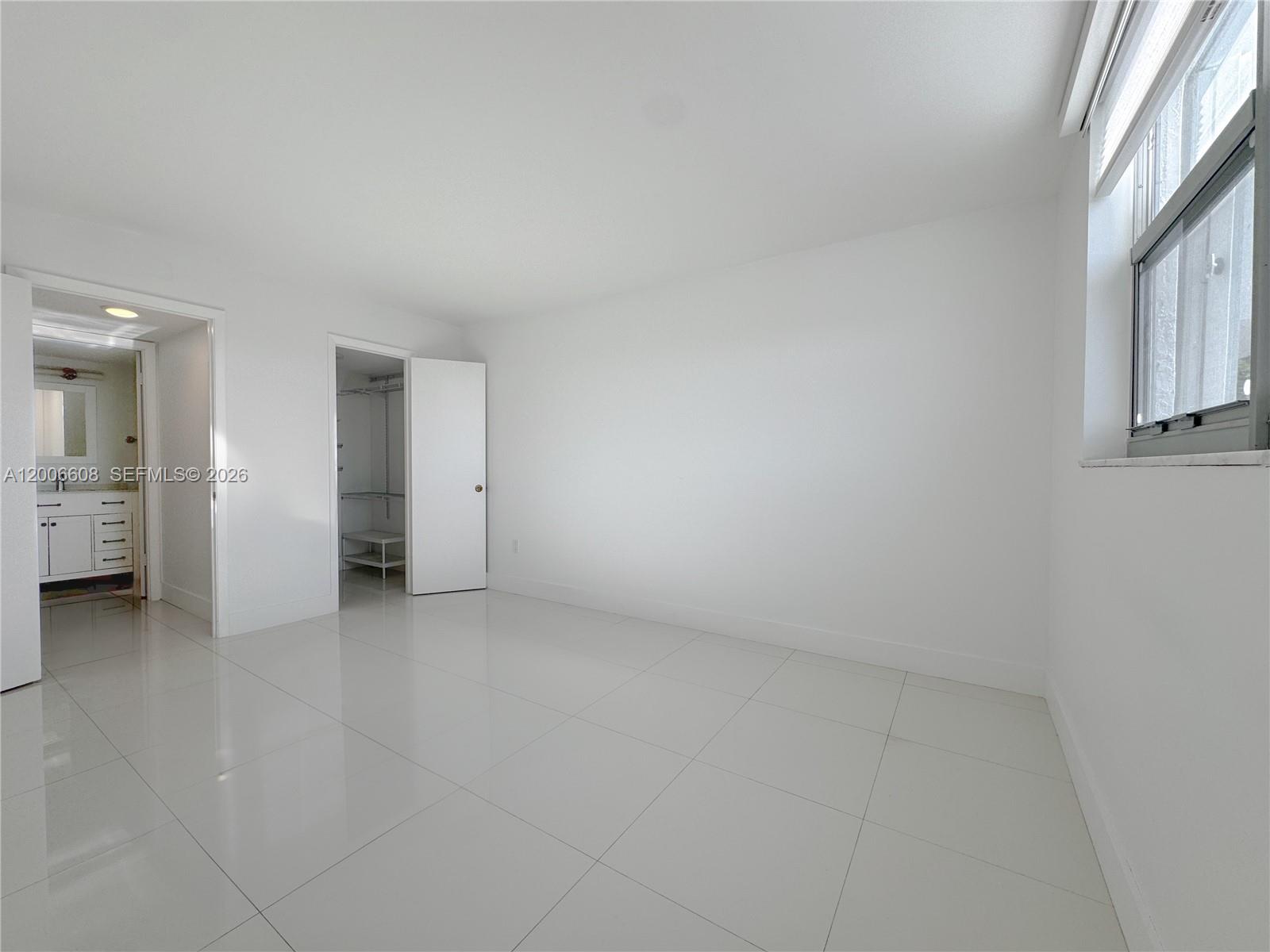 210 Seaview Drive, Unit 403 Key Biscayne, FL 33149 - Photo 9 of 31 an empty room with a bathroom and a window