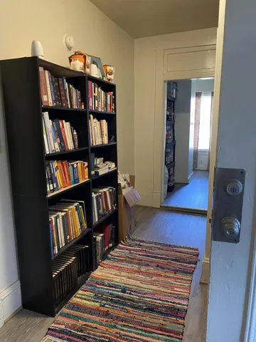 a view of bedroom with furniture and book shelf