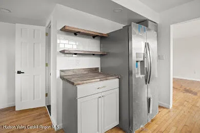 a kitchen with stainless steel appliances granite countertop a refrigerator and a stove