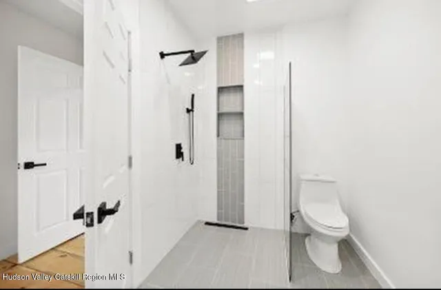 a bathroom with a toilet a sink and shower