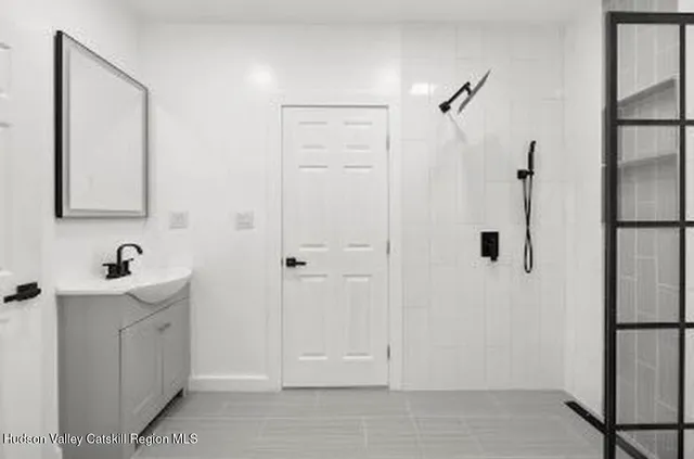 a bathroom with a sink and mirror