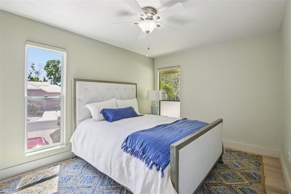 3390 Bayou Sound Longboat Key, FL 34228 - Photo 9 of 59 a bedroom with a large bed and a chandelier
