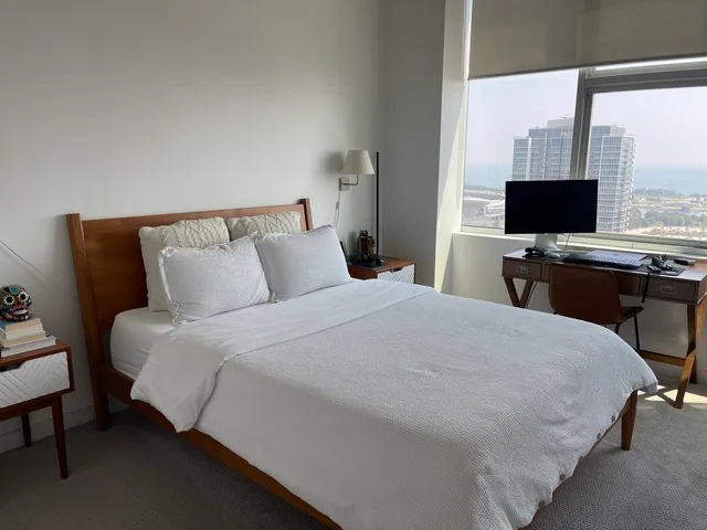 a bedroom with a bed and flat screen tv