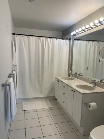 a bathroom with a double vanity sink and mirror