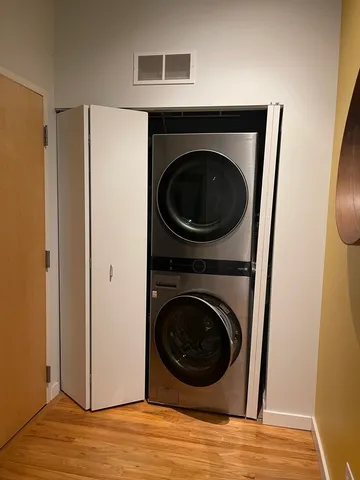 a view of a hallway with washer and dryer