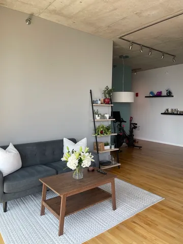 a living room with furniture and wooden floor