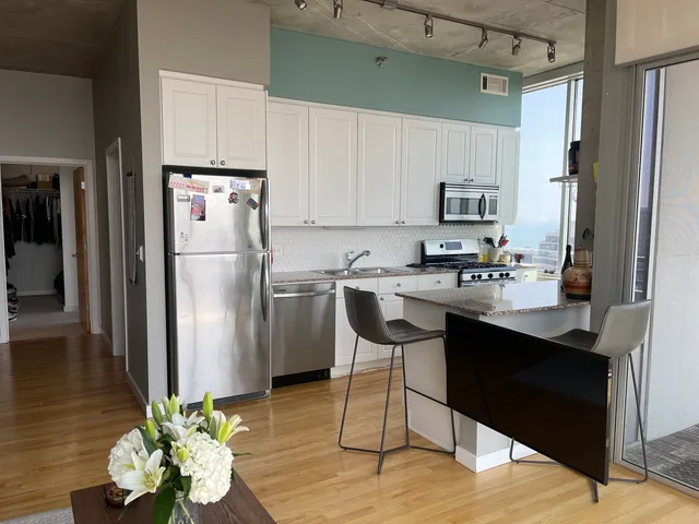 a kitchen with stainless steel appliances a refrigerator sink and cabinets