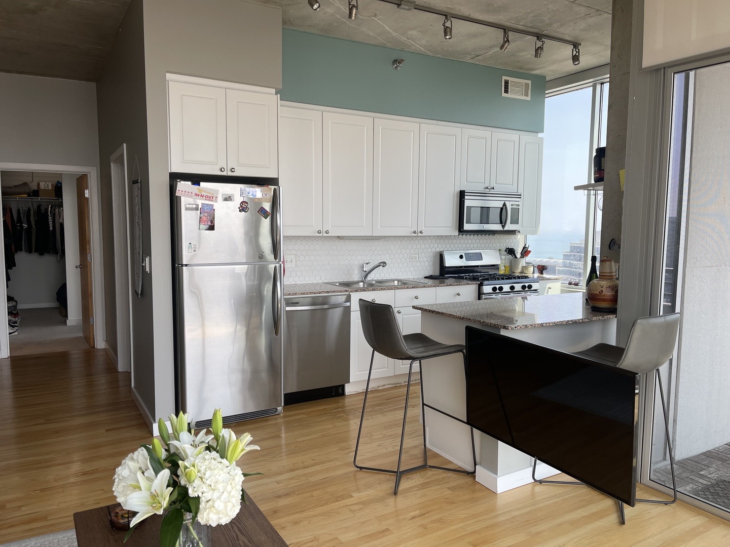 1720 South Michigan Avenue, Unit 2708 Chicago, IL 60616 - Photo 9 of 18 a kitchen with stainless steel appliances a refrigerator sink and cabinets