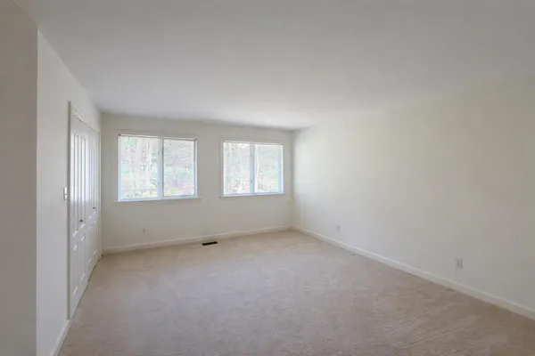 a backyard of a building with large trees