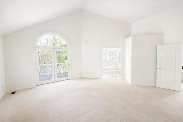 a view of a field with trees in the background
