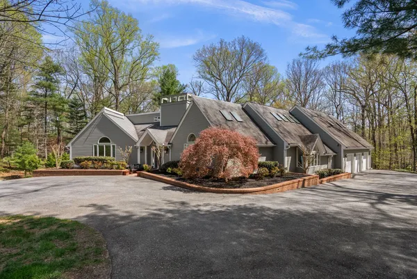 a big house with palm trees in the background