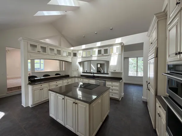 a kitchen with stainless steel appliances granite countertop a stove and a sink
