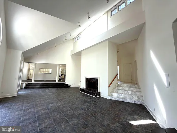 a bedroom with a bed and a refrigerator