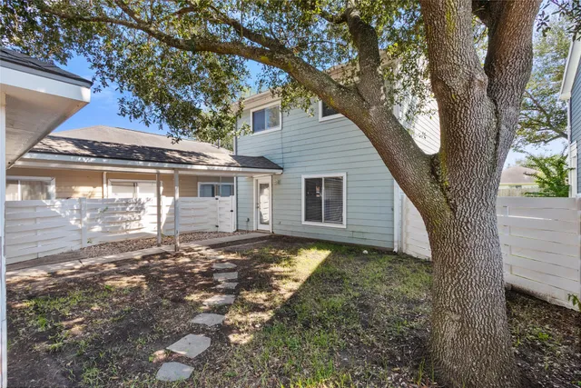 a view of a house with a tree