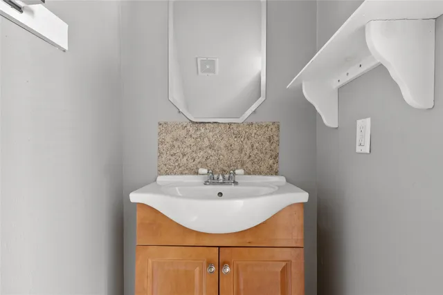a bathroom with a sink a mirror and vanity