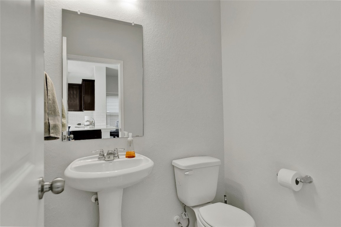 380 Witchhazel Way San Marcos, TX 78666 - Photo 10 of 22 a bathroom with a toilet sink and mirror