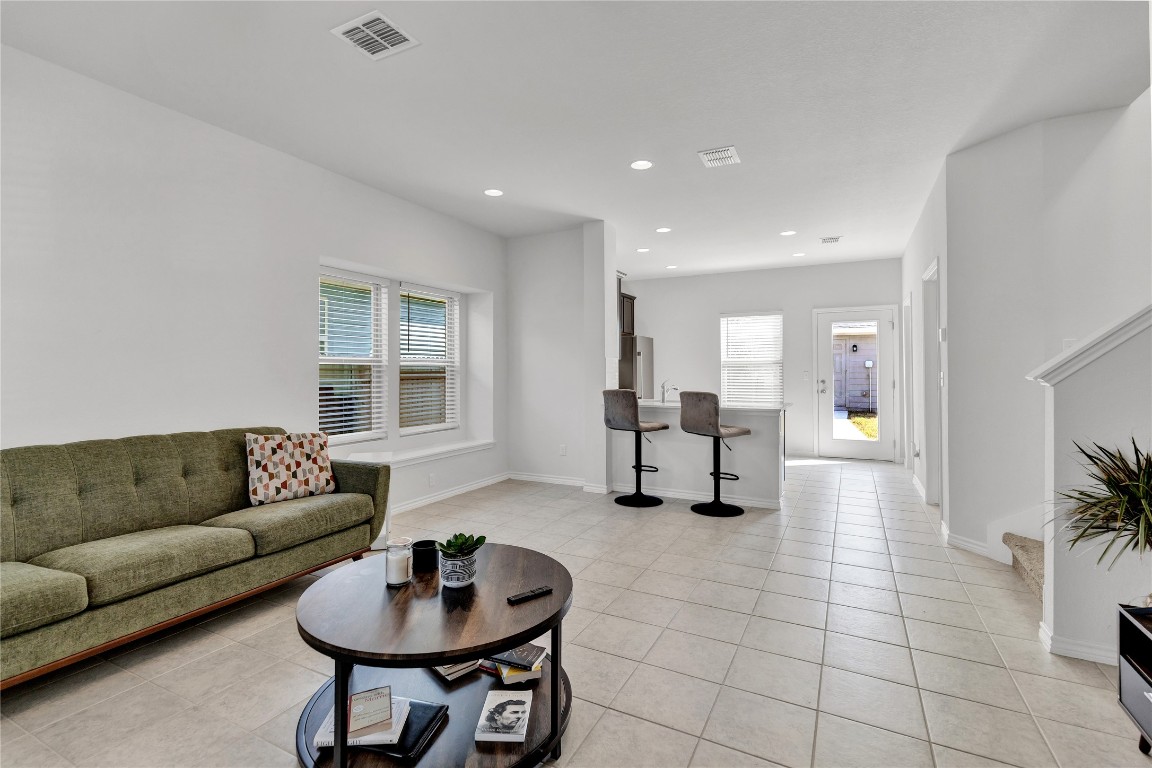 380 Witchhazel Way San Marcos, TX 78666 - Photo 7 of 22 a living room with furniture and a chandelier