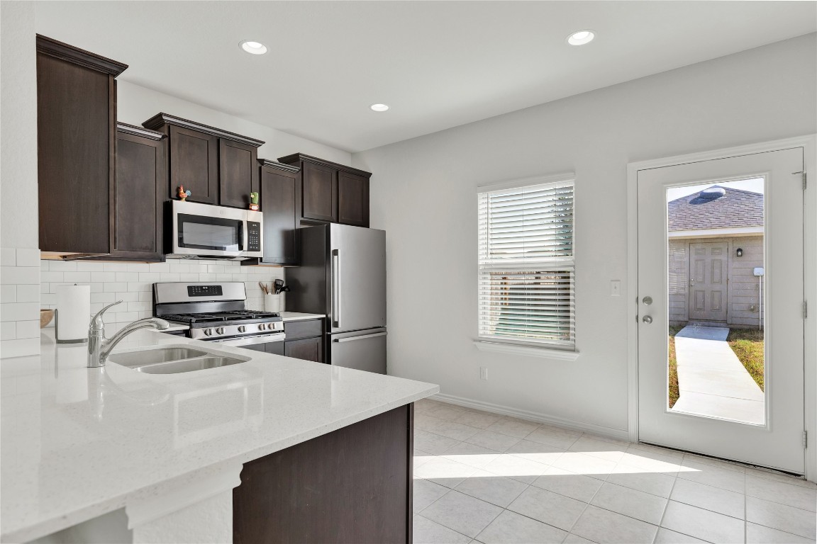 380 Witchhazel Way San Marcos, TX 78666 - Photo 9 of 22 a kitchen with stainless steel appliances granite countertop a refrigerator stove and sink