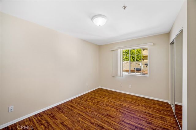 a view of a room with wooden floor and window