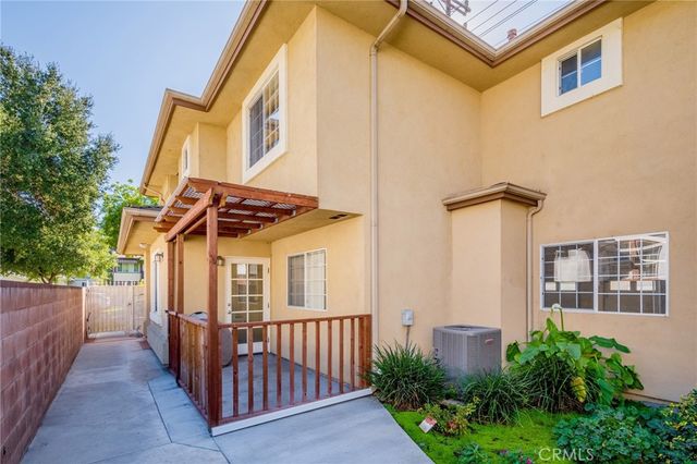 a view of a house with wooden fence