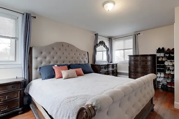 a bedroom with a large bed and a window