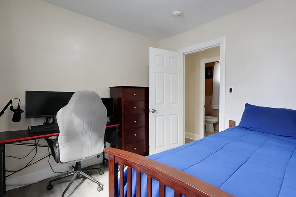 a bedroom with a bed and a chair