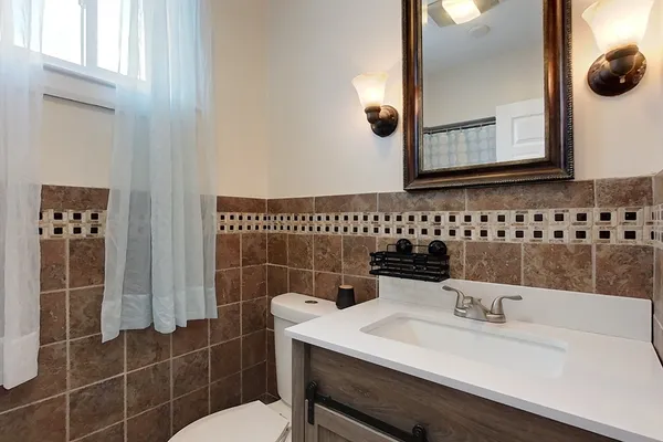 a bathroom with a sink a toilet and mirror