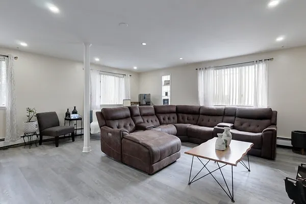a living room with furniture and a wooden floor