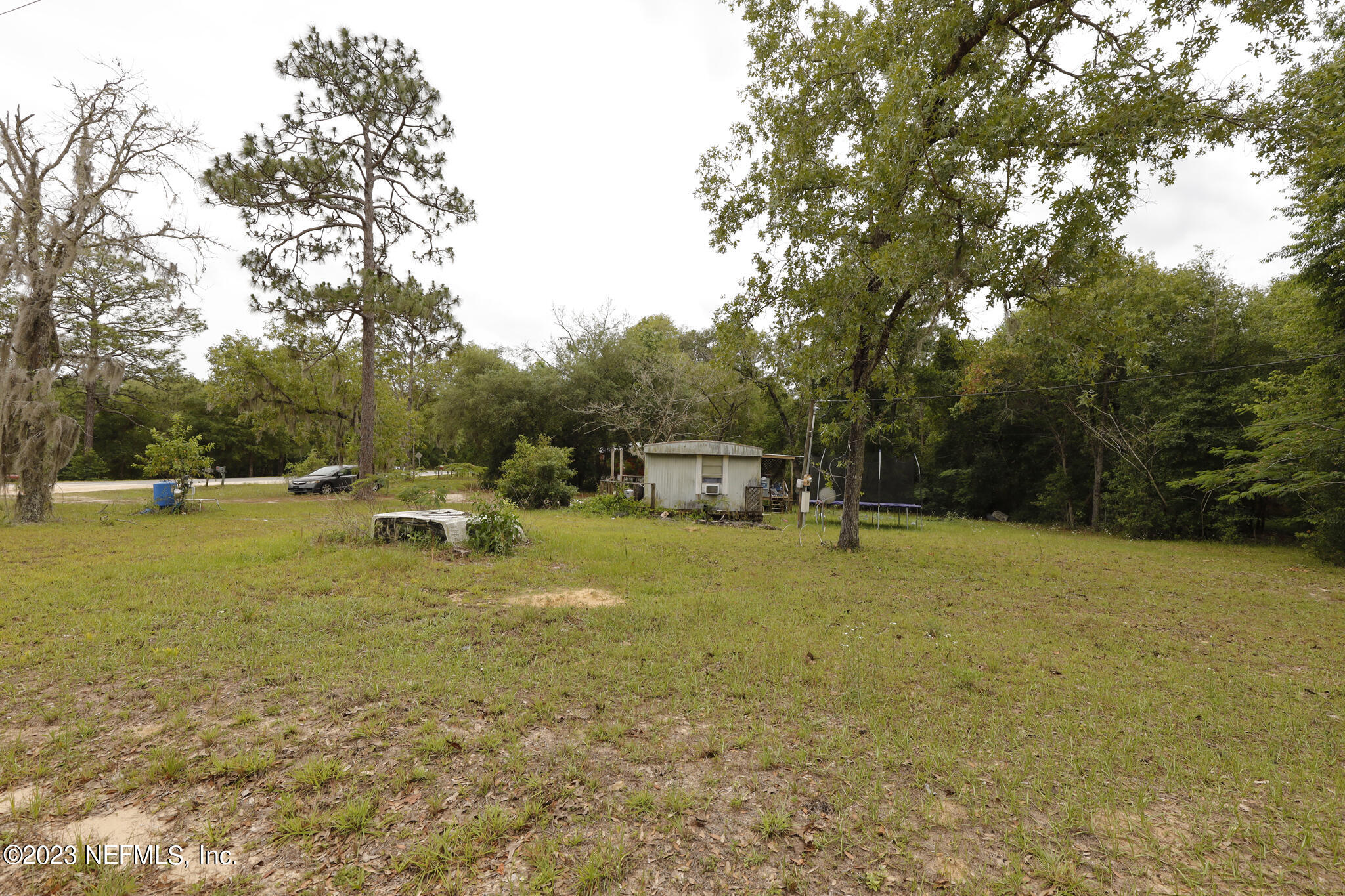 7354 Yale Street Keystone Heights, FL 32656 - Photo 7 of 13 a swimming pool with some trees in the background