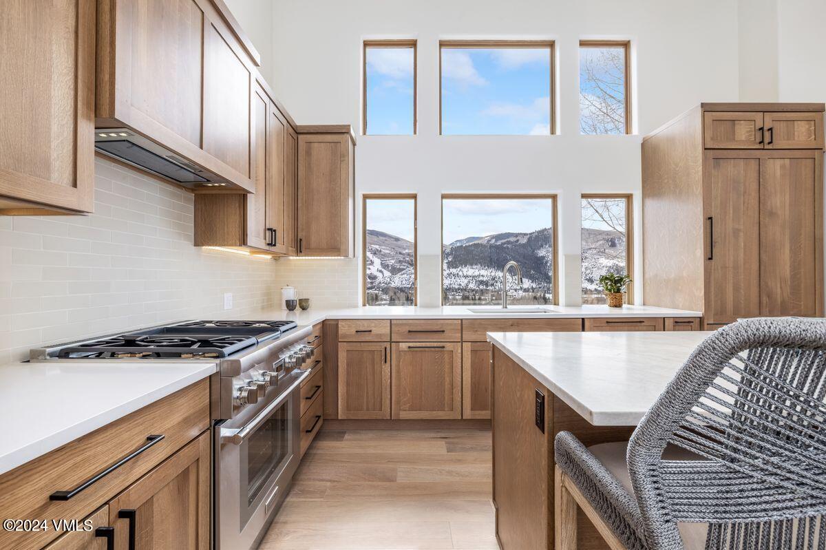751 Singletree Road, Unit 1 Edwards, CO 81632 - Photo 12 of 33 a kitchen with granite countertop a stove and a sink