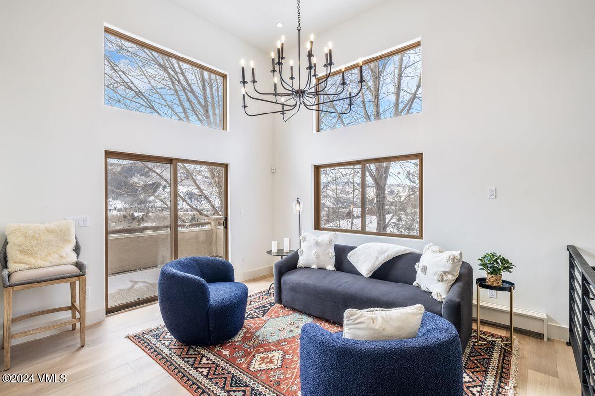 751 Singletree Road, Unit 1 Edwards, CO 81632 - Photo 2 of 33 a living room with furniture chandelier and a large window