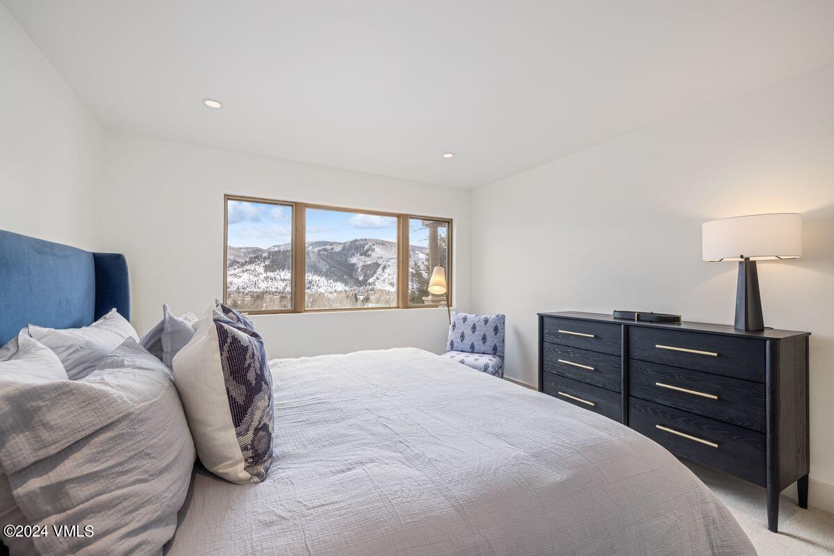 751 Singletree Road, Unit 1 Edwards, CO 81632 - Photo 23 of 33 a bedroom with a bed and a large window