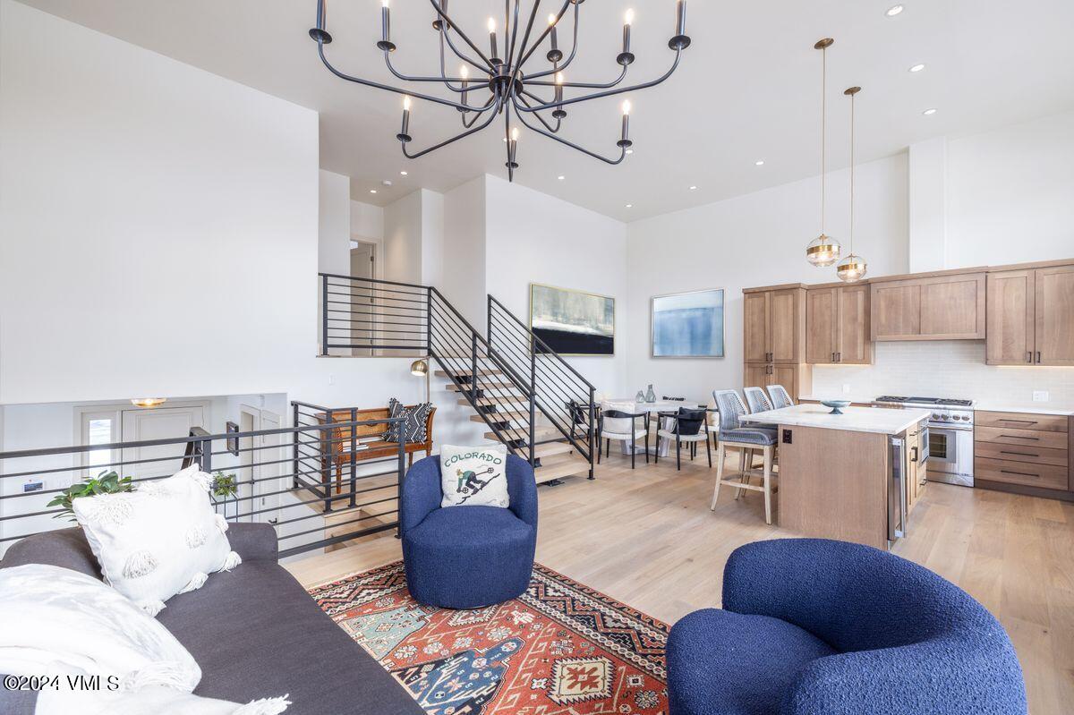 751 Singletree Road, Unit 1 Edwards, CO 81632 - Photo 4 of 33 a living room with lots of furniture kitchen view and a chandelier