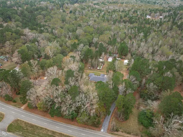 a aerial view of a house with yard swimming pool and lake view