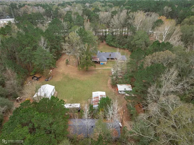 a view of a backyard with barn and large trees