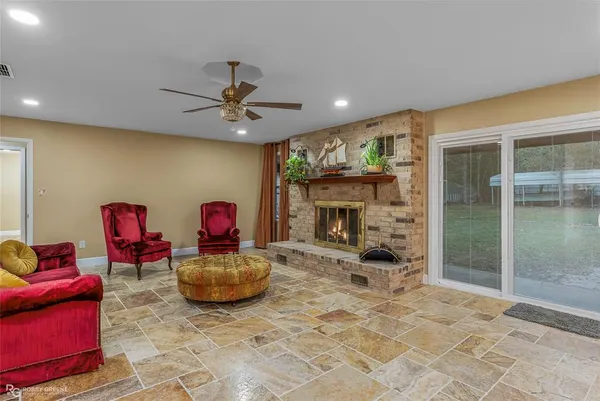 a view of a livingroom with a fireplace and a chandelier