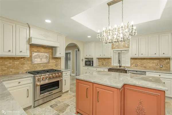 a kitchen with sink stove and cabinets