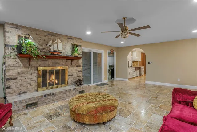 a view of a livingroom with a fireplace and a chandelier
