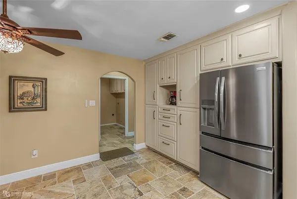 a kitchen with kitchen island granite countertop a stove oven and a sink with granite countertops
