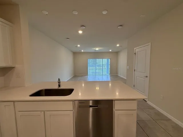 a view of kitchen with a sink and chandelier