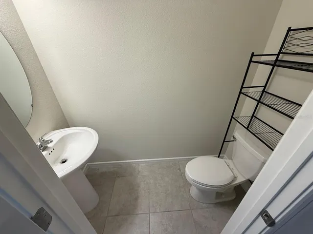 a bathroom with a toilet and a mirror