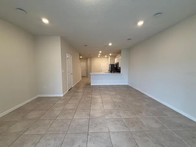 a view of a hallway with a kitchen